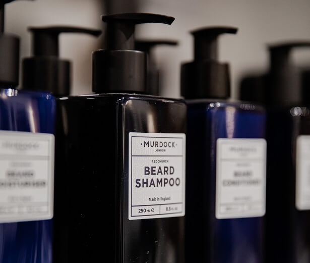 beard shampoo and conditioner bottols on a shelf