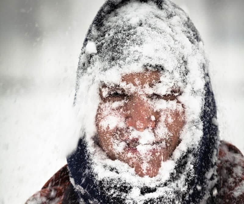 man with his whole head covered in snow